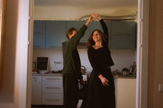 Couple dancing in a kitchen doorway